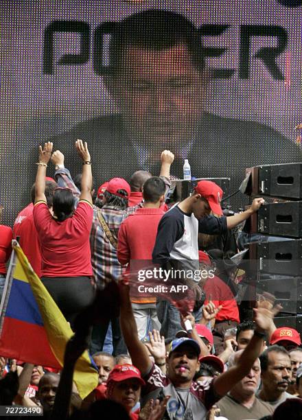 Venezuelan reelected President Hugo Chavez is seen on a giant screen during his speech at the National Election Council in Caracas 05 December, 2006....