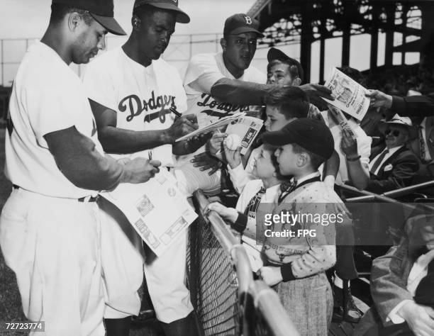 Brooklyn Dodgers signing autographs, 2nd June 1949. From left to right, Roy Campenella, Jackie Robinson and Don Newcombe.