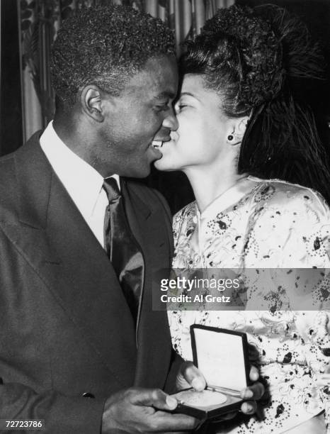 Brooklyn Dodger baseball player Jackie Robinson, and wife Rachel, with his Two Friends Award, presented for interracial team work between him and the...