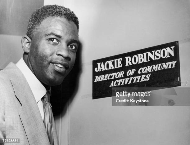 Jackie Robinson, Brooklyn Dodger's second baseman, outside the office that goes with his position of Director of Community Activities for NBC's New...