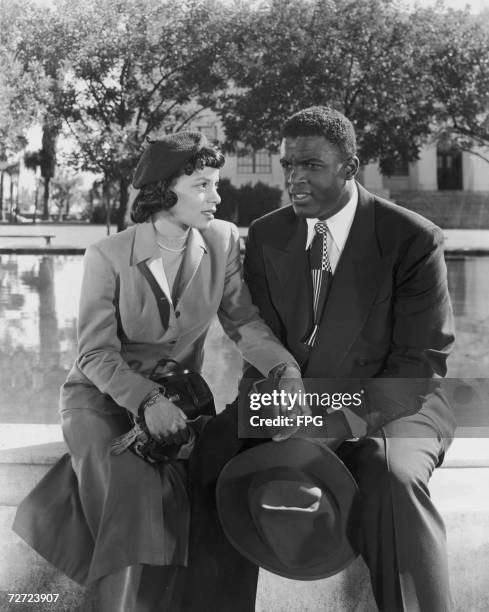 American baseball player Jackie Robinson of the Brooklyn Dodgers plays himself in the biopic 'The Jackie Robinson Story', 1950. Actress Ruby Dee...