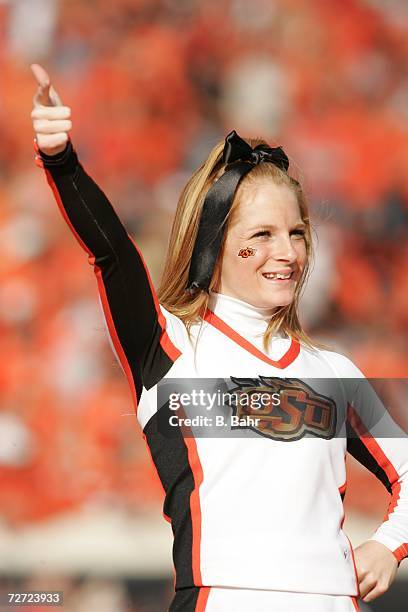An Oklahoma State Cowboys cheerleader entertains during a game against the Oklahoma Sooners on November 25, 2006 at Boone Pickens Stadium in...
