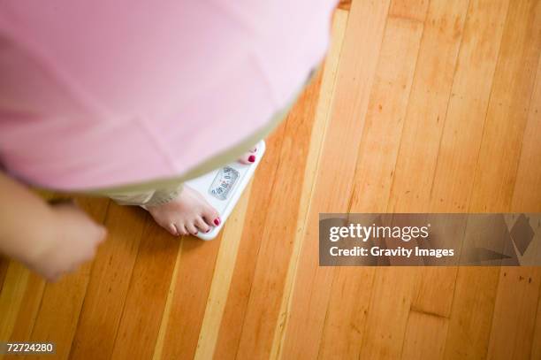 woman standing on scales, elevated view - bathroom scale stock pictures, royalty-free photos & images