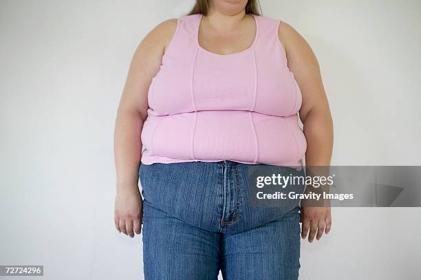 overweight woman, mid section - ärmelloses oberteil stock-fotos und bilder