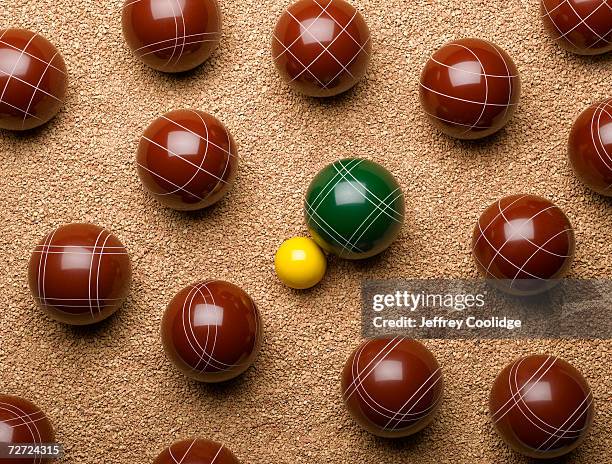 large balls on gravel with one small yellow ball in centre, overhead view - bocce ball stock pictures, royalty-free photos & images