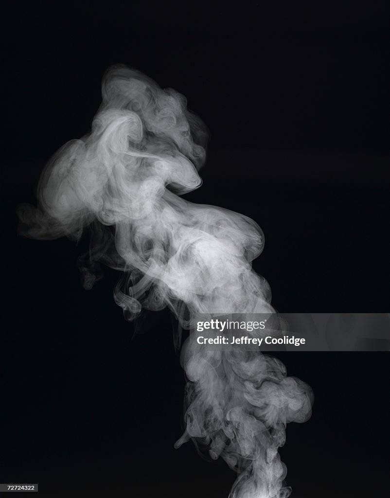 Vapour rising against dark background