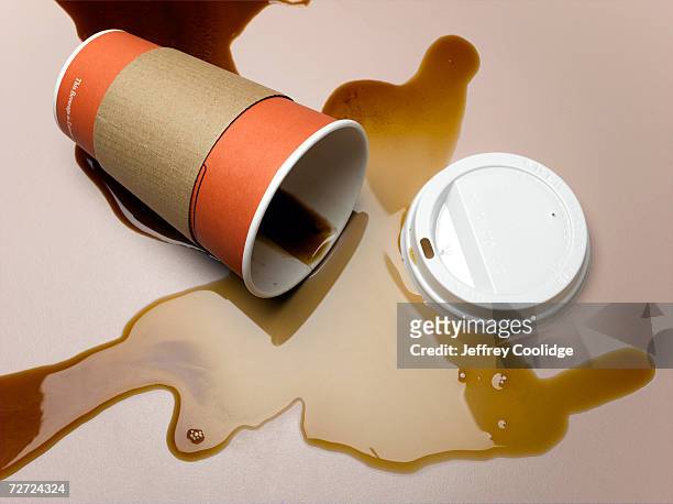 vending cup on side spilling coffee onto surface, elevated view, close-up - dump stock-fotos und bilder
