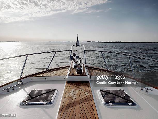 bow of ship with deck hatches and railing on calm sea - yacht foto e immagini stock