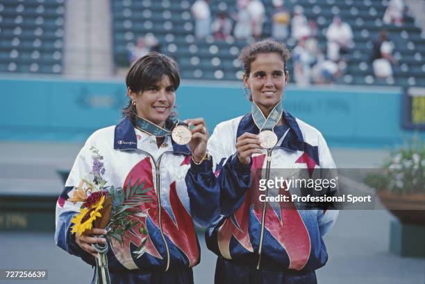 American tennis players Gigi Fernandez and Mary Joe Fernandez pictured together on the medal podium after finishing in first place to win the gold...