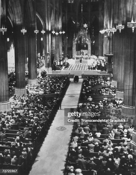 Babe Ruth lies in his coffin in St. Patricks Cathedral in New York City, as thousands attend his funeral service.