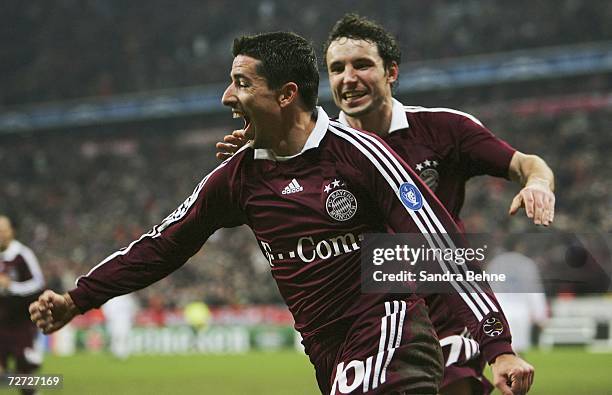 Roy Makaay of Bayern Munich celebrates after scoring the first goal with team mate Mark van Bommel during the UEFA Champions League Group B match...
