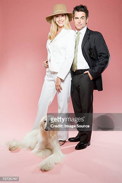 couple and an afghan hound - glamour couple stock pictures, royalty-free photos & images