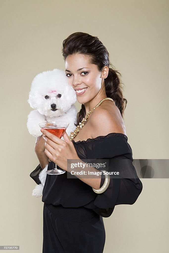 Woman holding dog and cocktail glass