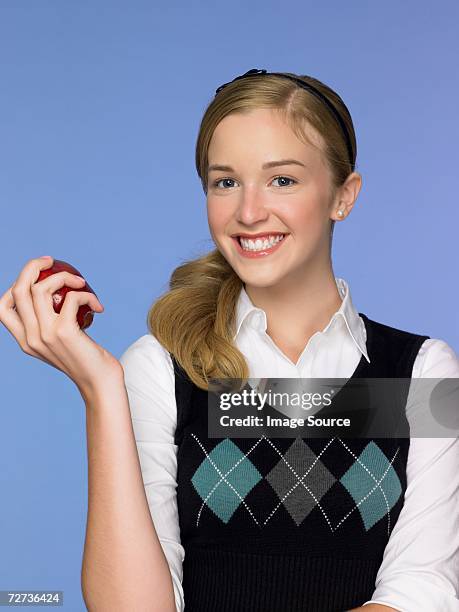 girl holding an apple - hair back stock pictures, royalty-free photos & images