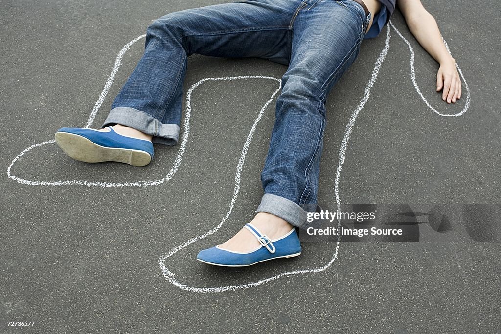 Chalk outline around a woman