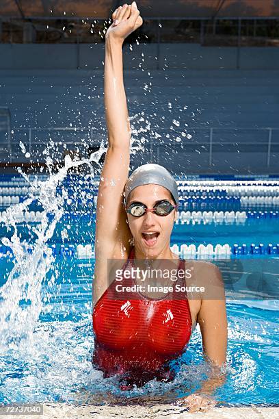 female swimmer winning race - swimming race imagens e fotografias de stock