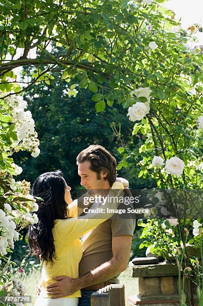 couple hugging in garden - garden gate rose stock pictures, royalty-free photos & images