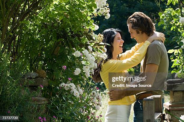 couple hugging in garden - garden gate rose stock pictures, royalty-free photos & images