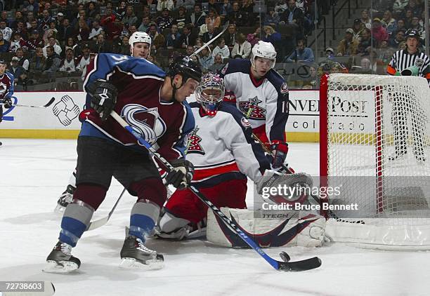 Tyler Arnason of the Colorado Avalanche circles the net in front of goaltender Fredrik Norrena of the Columbus Blue Jackets on December 5, 2006 at...