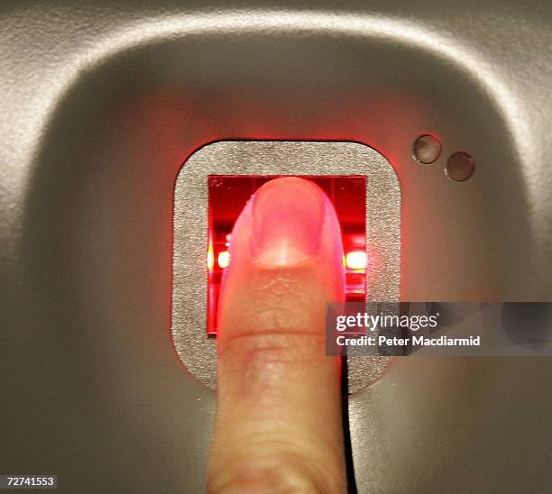 Man has his fingerprint scanned on a new biometric check in kiosk at terminal three on December 6, 2006 at London's Heathrow airport. The new check...