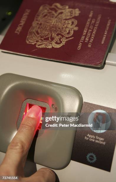 Man has his fingerprint scanned on a new biometric check in kiosk at terminal three on December 6, 2006 at London's Heathrow airport. The new check...