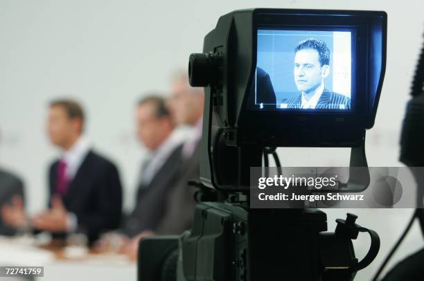 Mobile CEO and Deutsche Telekom board member Hamid Akhavan is filmed by a camera monitor as he attends a news conference December 6, 2006 in Bonn,...