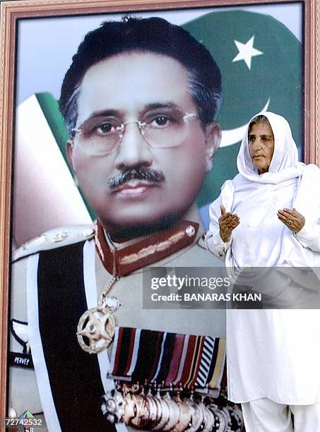 Pakistani elderly woman stands next to the portrait of President Pervez Musharraf in Quetta, the capital of southwestern Baluchistan province, 06...