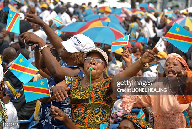 Kinshasa, Democratic Republic of the Congo: A woman waves the Congolese national flag during an inauguration ceremony for the new president Joseph...