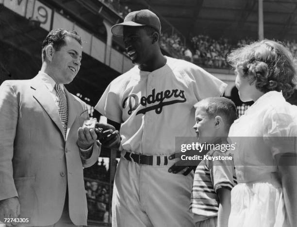 Brooklyn Dodgers baseball player Jackie Robinson is awarded the title of Sports Father of the Year by Francis Duffy , Worker Father of The Year, as...