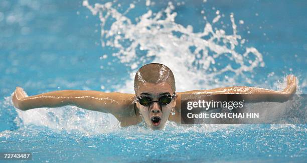 Ten-year-old Amer Ali of Iraq competes in heat 2 of the men's 200m individual medley swimming event at the Hamad Aquatic Centre during the 15th Asian...