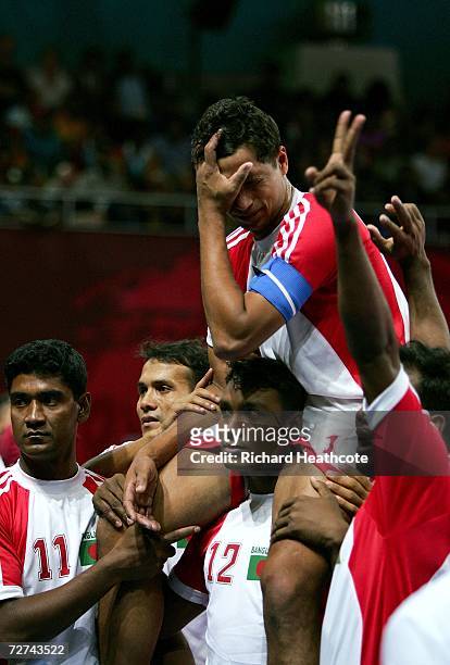 Md Ziaur Rahman and Kamal Hossain of Bangladesh celebrate with their team mates after defeating Islamic Republic of Iran in the Men's Kabaddi Bronze...