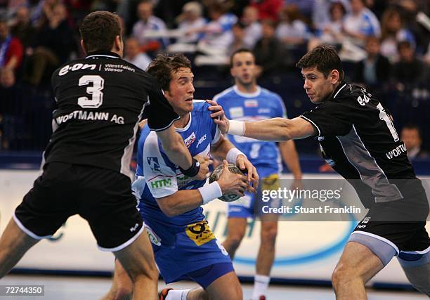 Torsten Jansen of Hamburg is challenged by Jakub Szymanski and Branko Kokir of Lubeck during the Bundesliga game between HSV Handball and TUS...