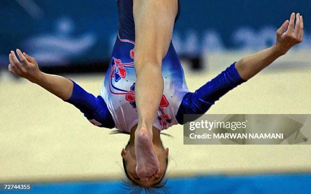 Japanese gymnast Miki Uemura performs in the women's beam apparatus final 06 December 2006 at the Aspire compound during the 15th Asian Games in...