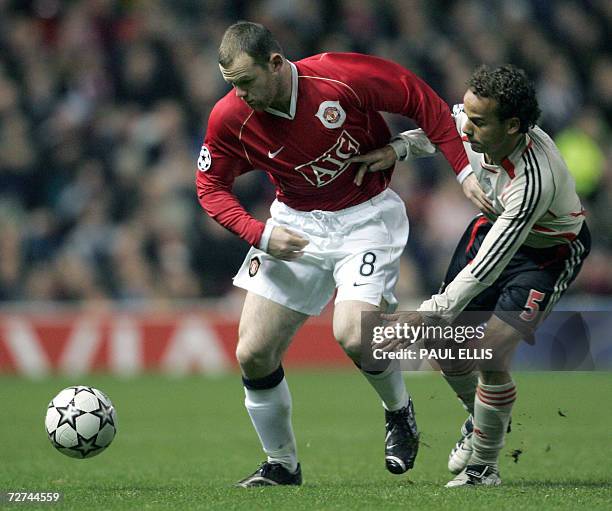 Manchester, UNITED KINGDOM: Manchester United's Wayne Rooney vies with Benfica's Leo during their UEFA Champions League Group F football match at Old...