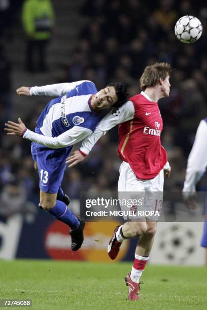 Arsenal FC's Belarus midfielder Aleksandr Hleb jumps for the ball with FC Porto's Uruguayan defender Jorge Fucile during their UEFA Champions League...