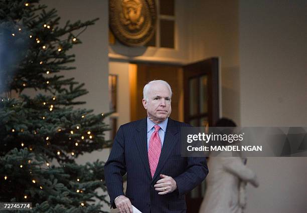 Washington, UNITED STATES: Senator John McCain makes his way to speak to the press after attending a bicameral meeting on the Iraq Study Group report...