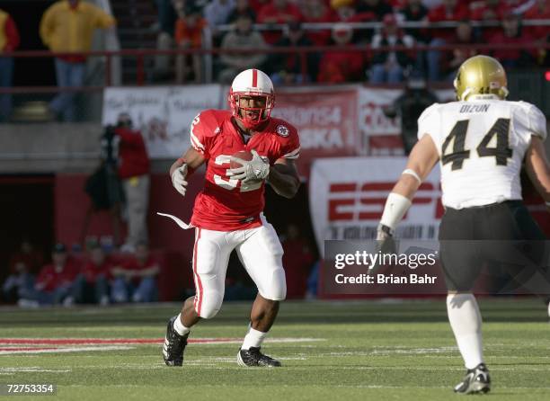 Brandon Jackson of the Nebraska Cornhuskers runs against inside linebacker Jordon Dizon of the Colorado Buffaloes on November 24, 2006 at Memorial...