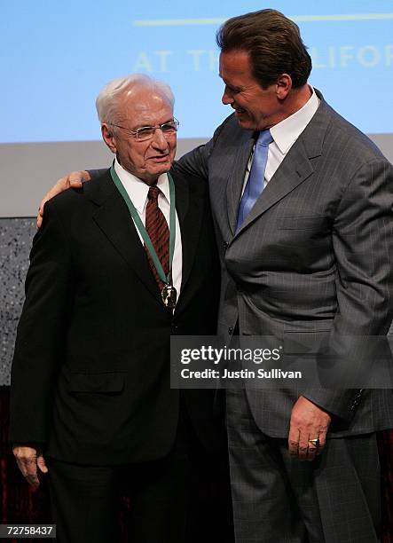 California Gov. Arnold Schwarzenegger hugs architect Frank Gehry after he was inducted in the first ever California Hall of Fame December 6, 2006 in...