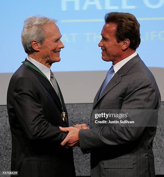 California Gov. Arnold Schwarzenegger shakes hands with actor Clint Eastwood after Eastwood was inducted into California Hall of Fame December 6,...