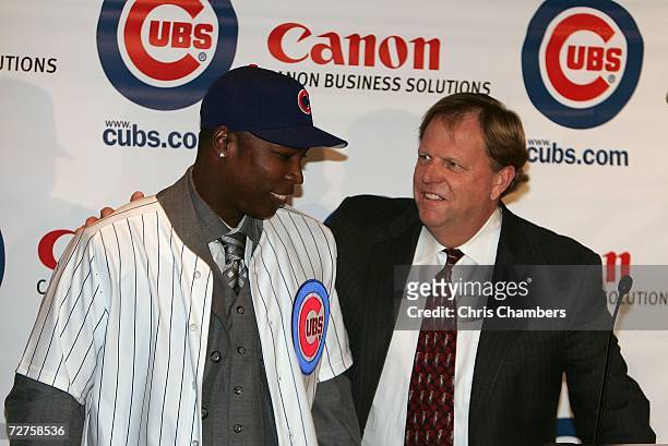 General manager Jim Hendry of the Chicago Cubs introduces Alfonso Soriano during a press conference to announce the sigining of Soriano to an eight...