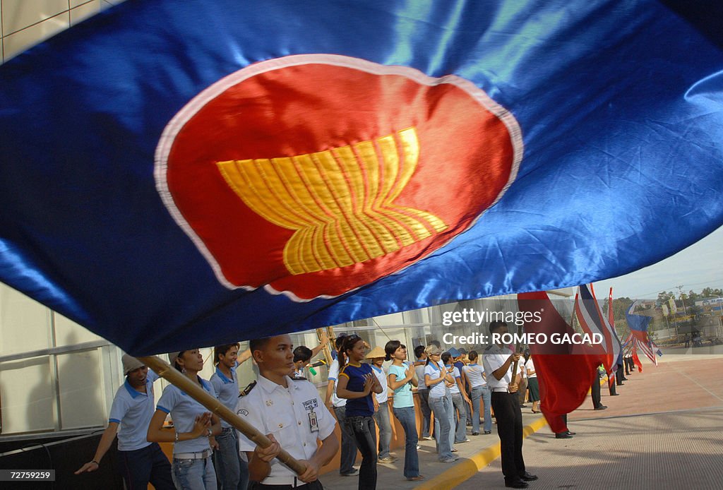 Students carrying ASEAN flags practice o