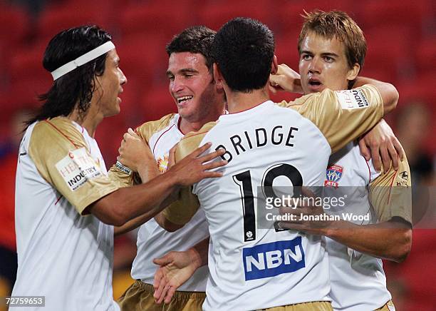 Joel Griffiths of the Jets celebrates scoring with team-mates during the round 16 Hyundai A-League match between the Queensland Roar and the...