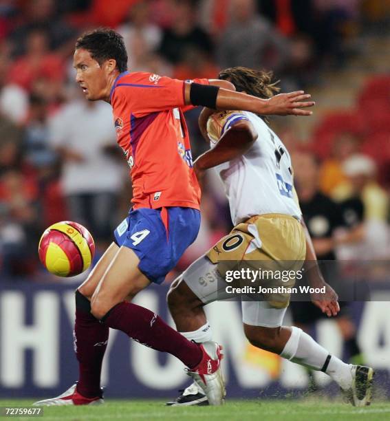 Chad Gibson of the Roar shields the ball from Nick Carle of the Jets during the round 16 Hyundai A-League match between the Queensland Roar and the...