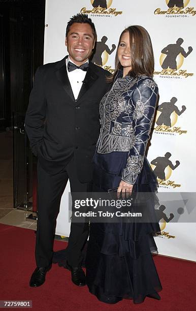 Oscar De la Hoya and Millie Corretjer pose at the Oscar De La Hoya Foundation Evening of Champions held at the Beverly Hilton Hotel December 6, 2006...