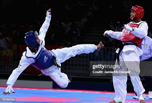 Adli Ghanem of Yeman competes with Maree Thabaya of Palestinian Territory in the Men's 54kg Taekwondo match during the 15th Asian Games Doha 2006 at...