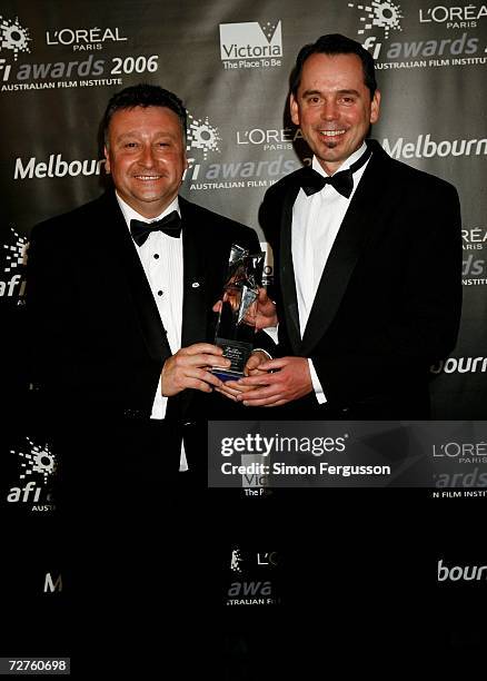Michael Cusack and unidentified guest poses with the AFI Award for Best Short Annimation for "Gargoyle" at the L'Oreal Paris 2006 AFI Awards at the...