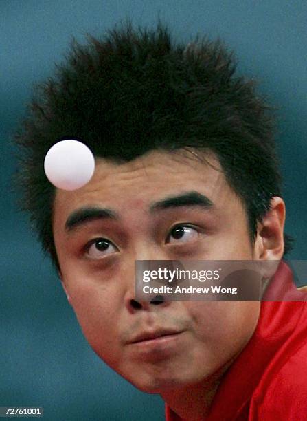 Wang Hao of China eyes the ball as he serves during the Men's Table Tennis singles final during the 15th Asian Games Doha 2006 at the Al-Arabi Indoor...