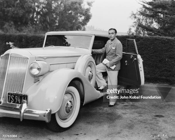 French actor Charles Boyer gets into a 1935 Packard, circa 1935.