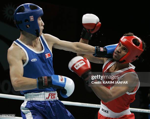 Saudi Mayouf Ahmed fights with Kim Song Guk of North Korea during their 57kg boxing quarter-final bout at the 15th Asian Games in Doha in Doha 07...
