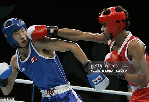 Saudi Mayouf Ahmed fights with Kim Song Guk of North Korea during their 57kg boxing quarter-final bout at the 15th Asian Games in Doha in Doha 07...